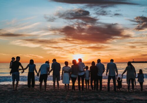 Group family photo at beach sunset