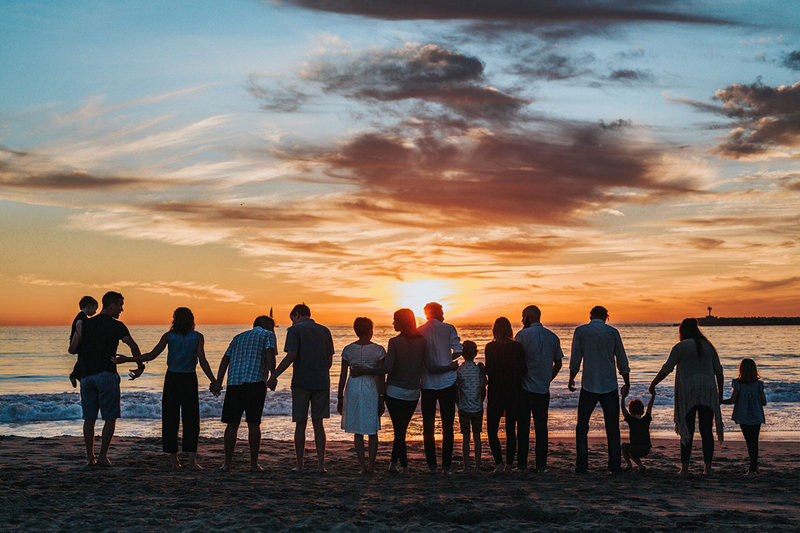 Group family photo at beach sunset