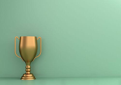 Gold trophy on green background