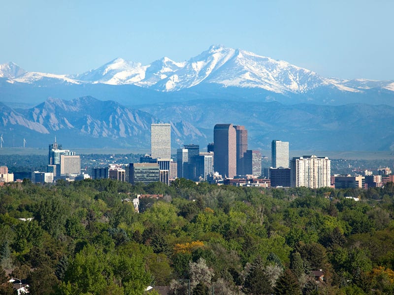 Denver, Colorado city skyline with snow capped mountains