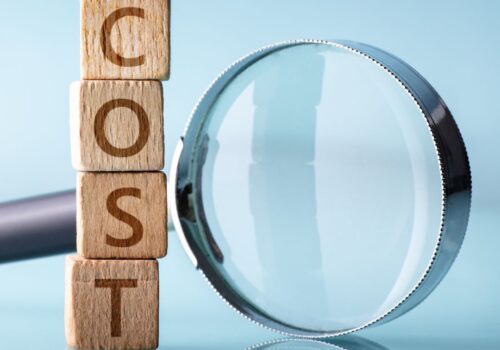 building blocks spell cost with magnifiying glass