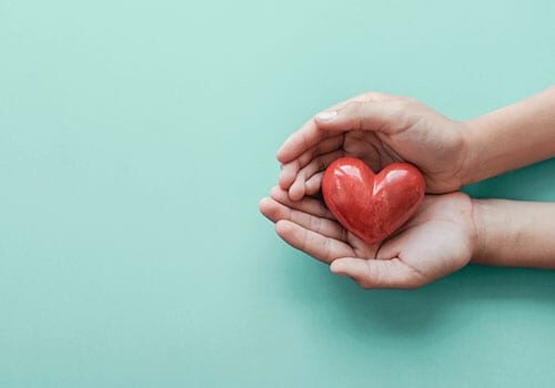 hand holding red heart